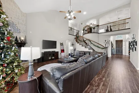 a living room with furniture and a chandelier