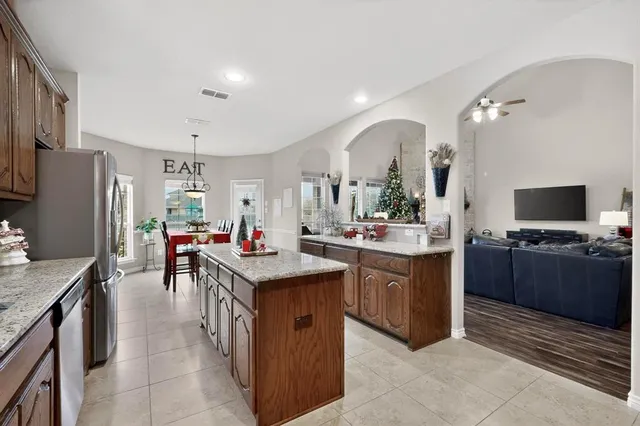 a kitchen with stainless steel appliances granite countertop a sink counter space and refrigerator