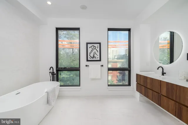 a white bath tub sitting next to a white toilet