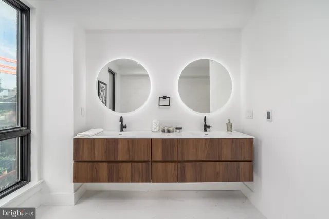 a bathroom with a double vanity sink and a mirror