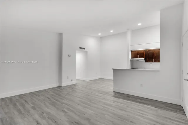 a kitchen with a refrigerator sink and cabinets