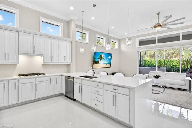 a kitchen with white cabinets and sink