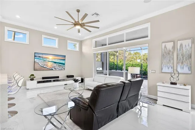 a living room with furniture a large window and a flat screen tv