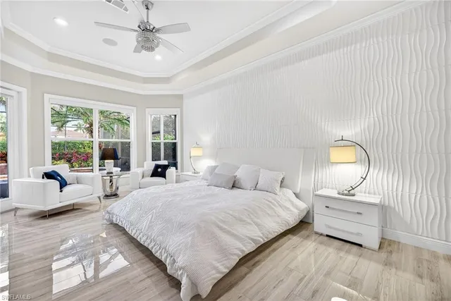 a bedroom with a large bed and a large window