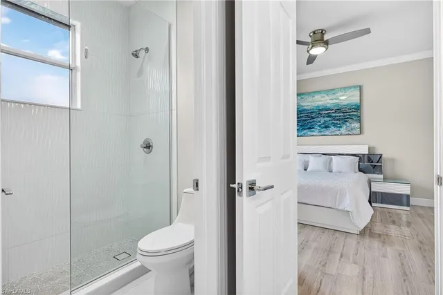 a bathroom with a toilet a sink and shower