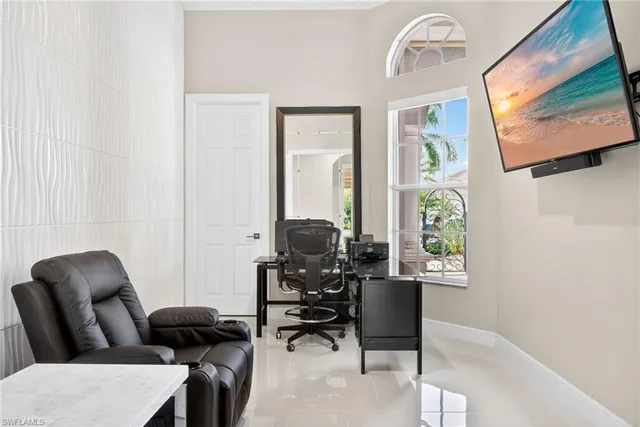 a work room with furniture and a window