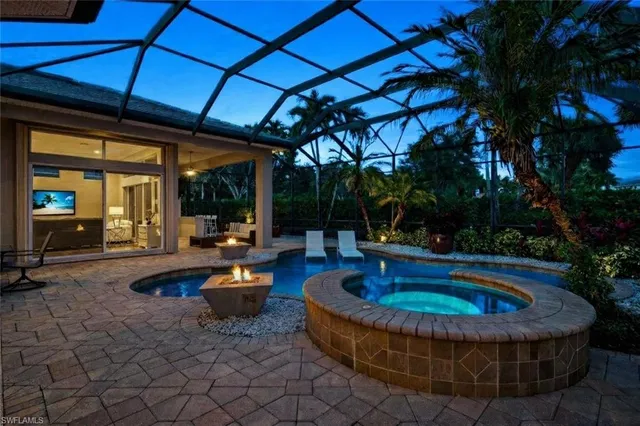 a dining room with furniture and large windows