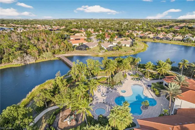 an aerial view of residential houses with outdoor space and swimming pool