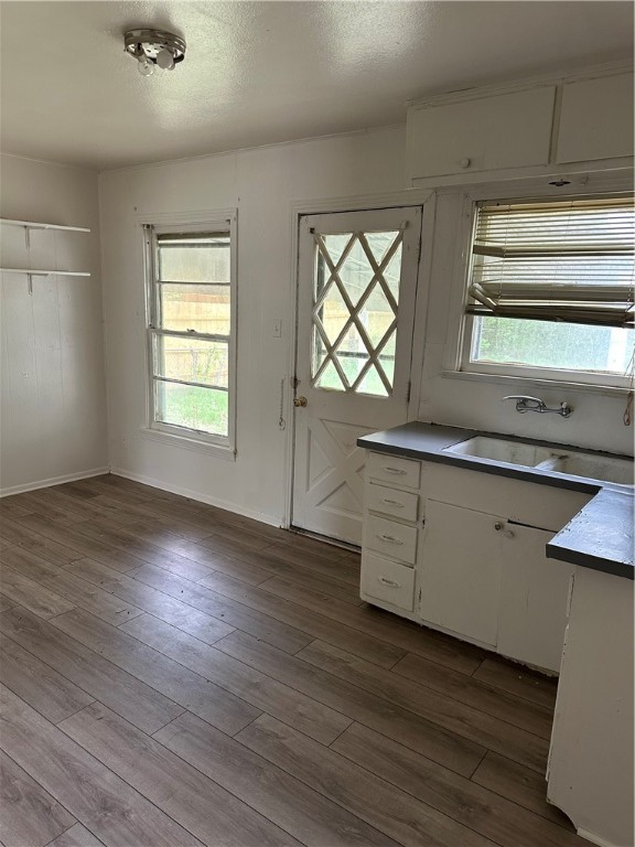 1912 Mabry Street Waco, TX 76711 - Photo 4 of 7 an empty room with wooden floor and windows
