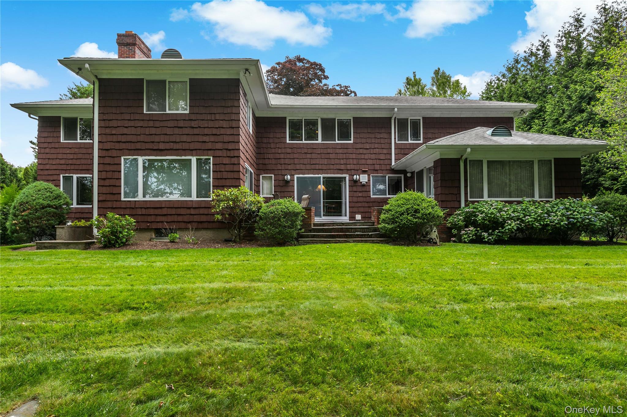 16 Meadow Road Scarsdale, NY 10583 - Photo 33 of 47 a front view of a house with garden
