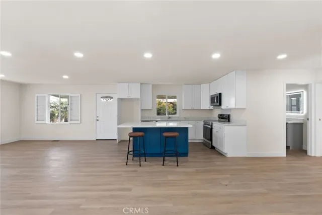 a living room with kitchen island furniture and a kitchen view