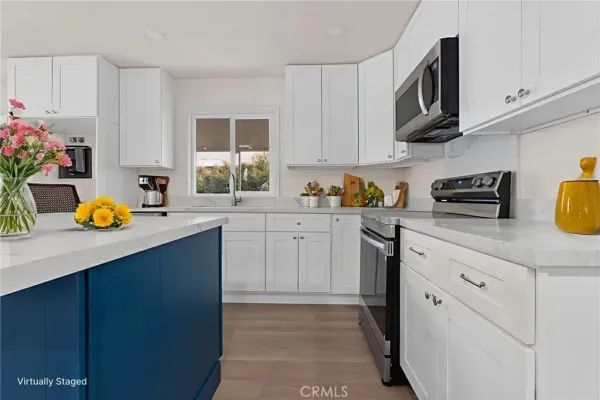 a kitchen with a refrigerator and a stove top oven