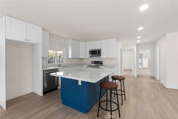 a living room with kitchen island furniture and a kitchen view