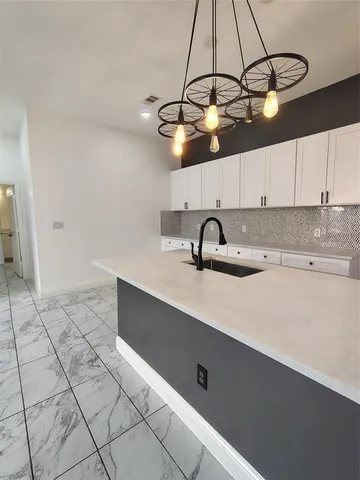 a kitchen with a sink cabinets and window