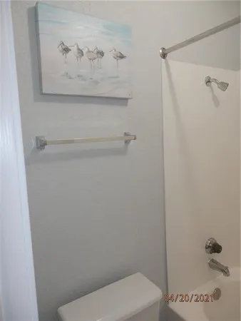 a white toilet sitting next to a bathroom sink