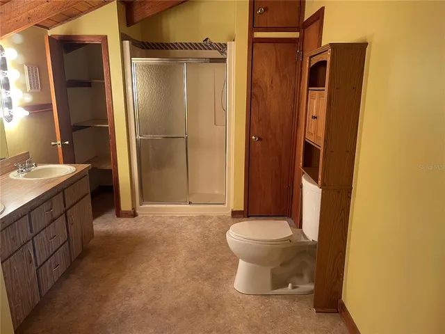 a bathroom with a sink toilet and shower