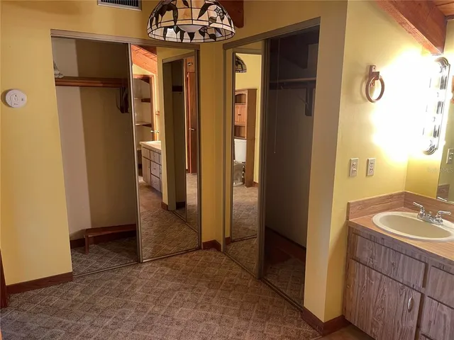 a view of a hallway with bathroom