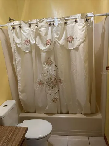 a bathroom with a toilet and shower