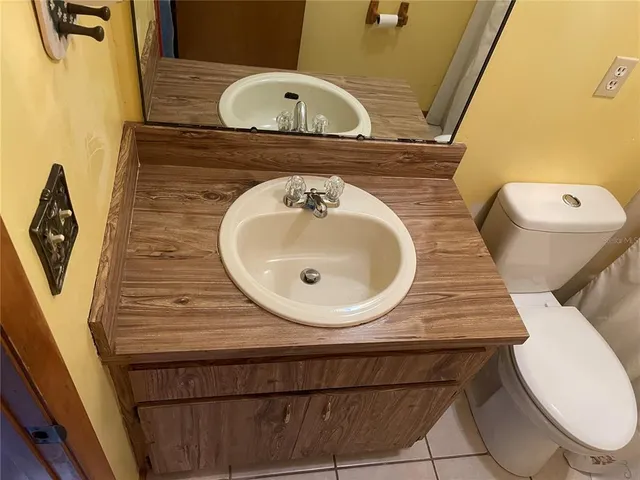 a bathroom with a sink a mirror and toilet