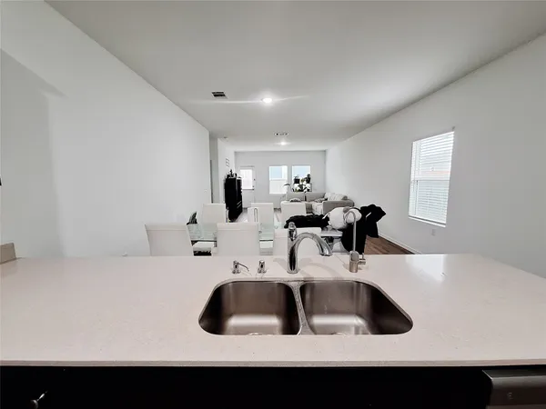 a kitchen with a sink and white cabinets
