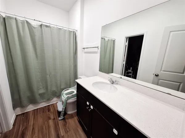 a bathroom with a double vanity sink toilet and a mirror