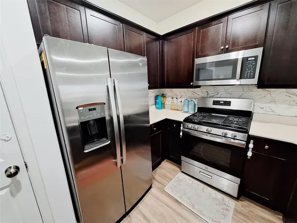 a kitchen with a refrigerator stove and microwave