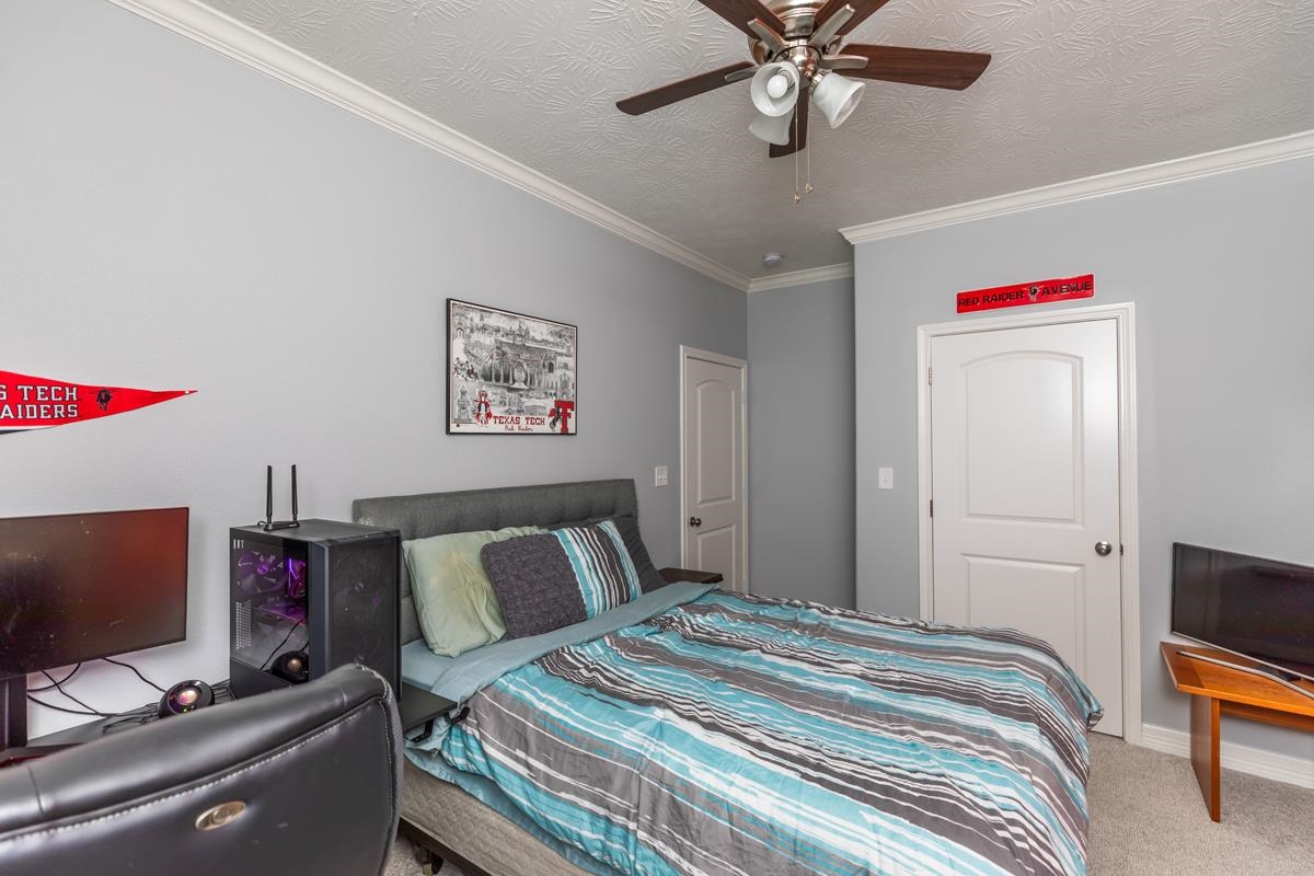 314 Long Leaf Street Silsbee, TX 77656 - Photo 21 of 31 a bedroom with a bed and a flat screen tv