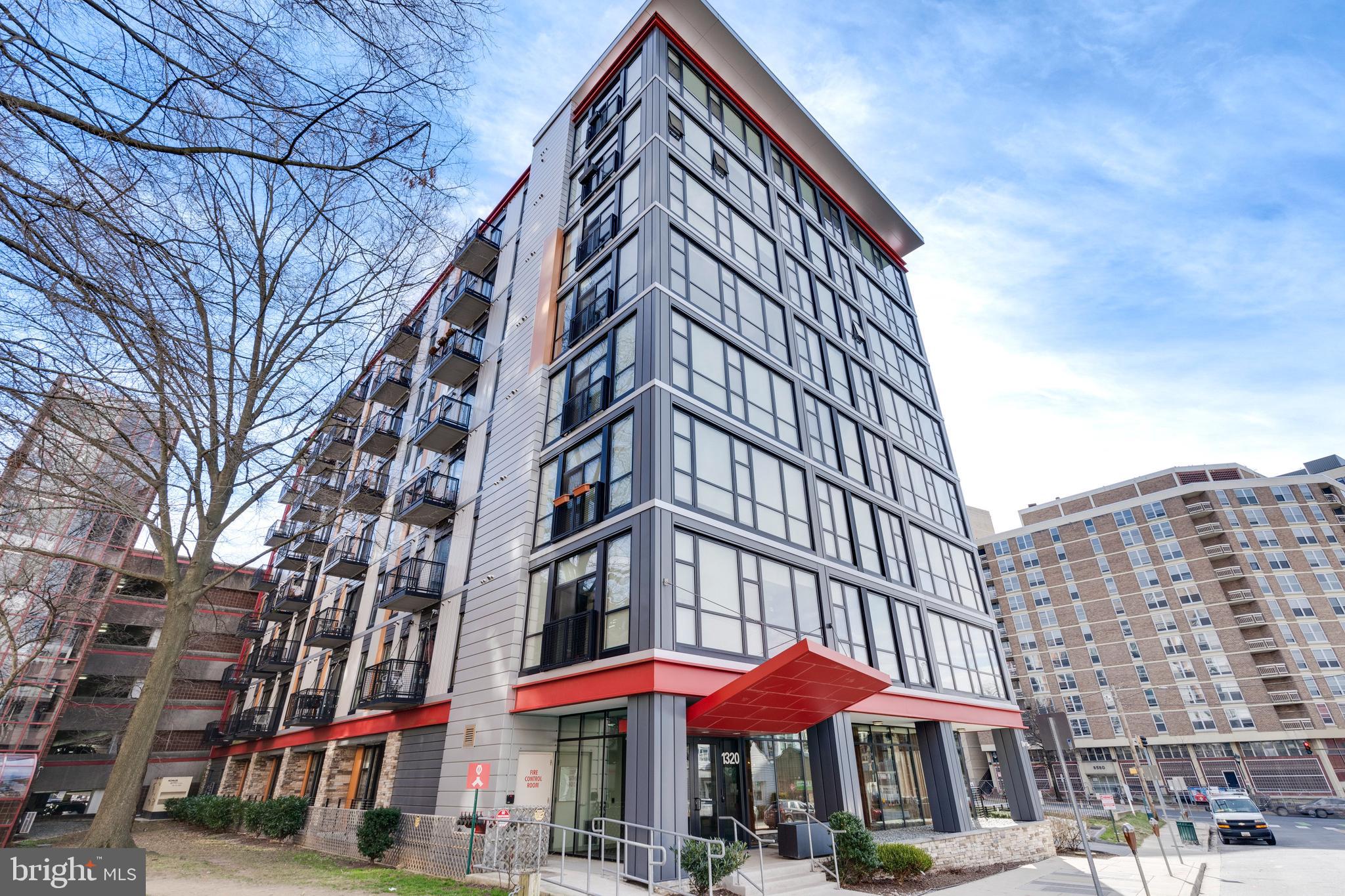 1320 Fenwick Lane, Unit 304 Silver Spring, MD 20910 - Photo 2 of 64 a view of a large building with a lot of trees