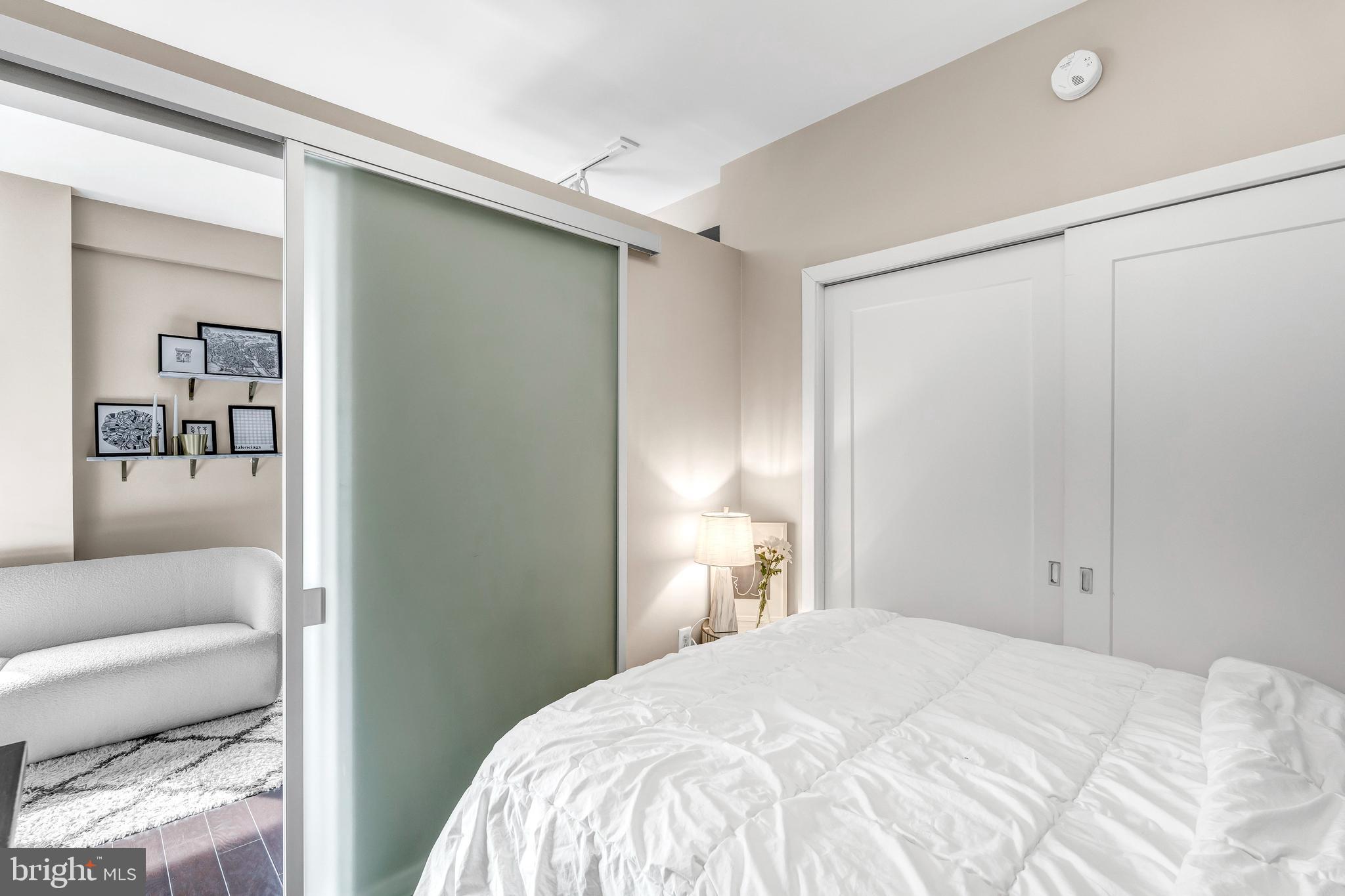 1320 Fenwick Lane, Unit 304 Silver Spring, MD 20910 - Photo 25 of 64 a bedroom with a bed and a couch