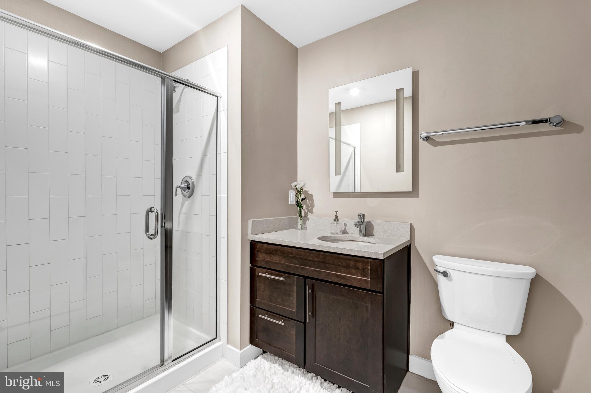 1320 Fenwick Lane, Unit 304 Silver Spring, MD 20910 - Photo 46 of 64 a bathroom with a toilet sink and shower