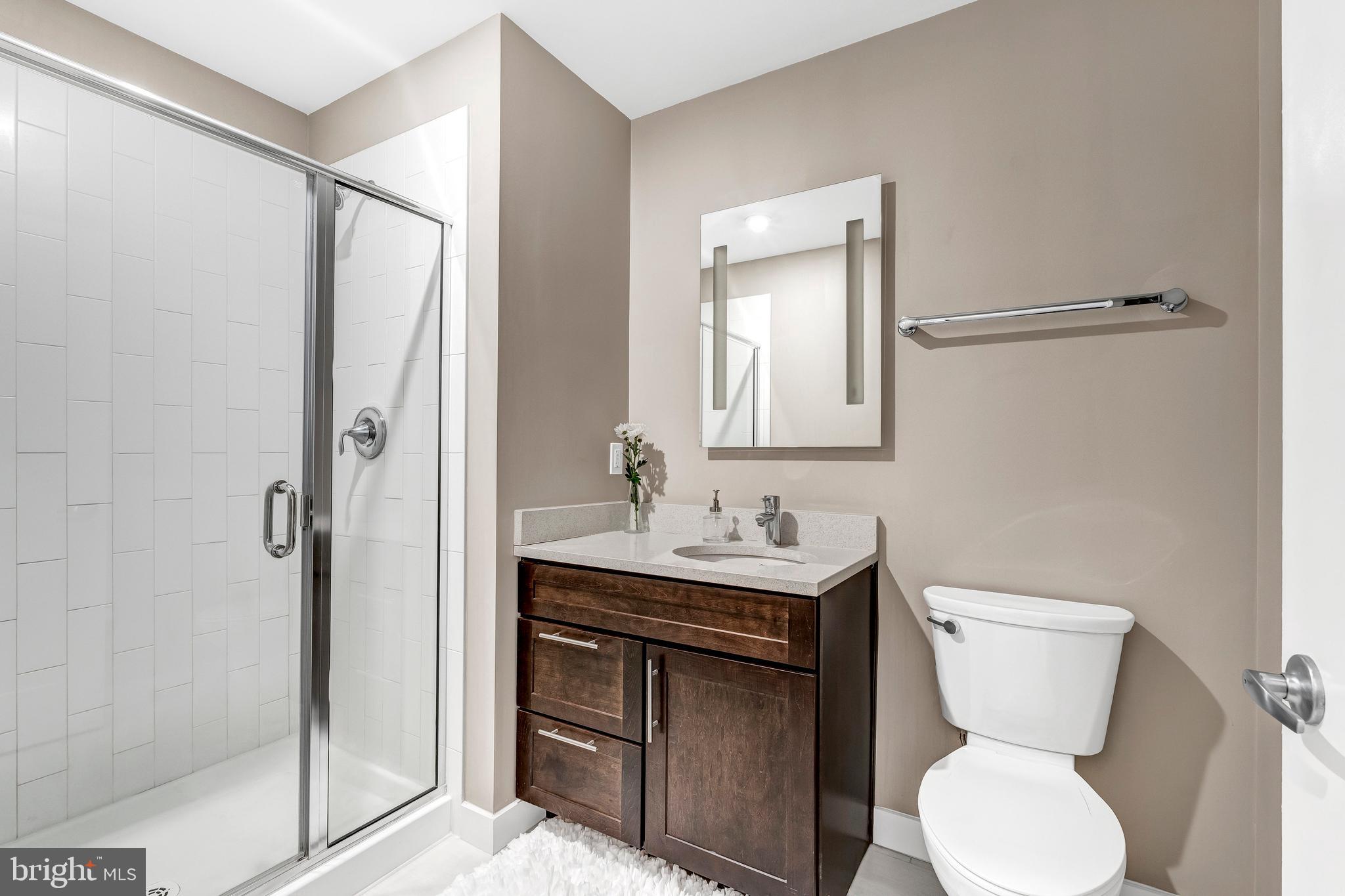 1320 Fenwick Lane, Unit 304 Silver Spring, MD 20910 - Photo 47 of 64 a bathroom with a toilet sink and shower