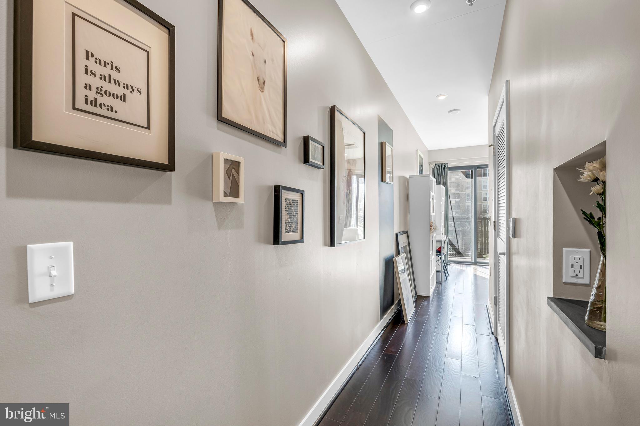 1320 Fenwick Lane, Unit 304 Silver Spring, MD 20910 - Photo 50 of 64 a hallway with white cabinets and wooden floor