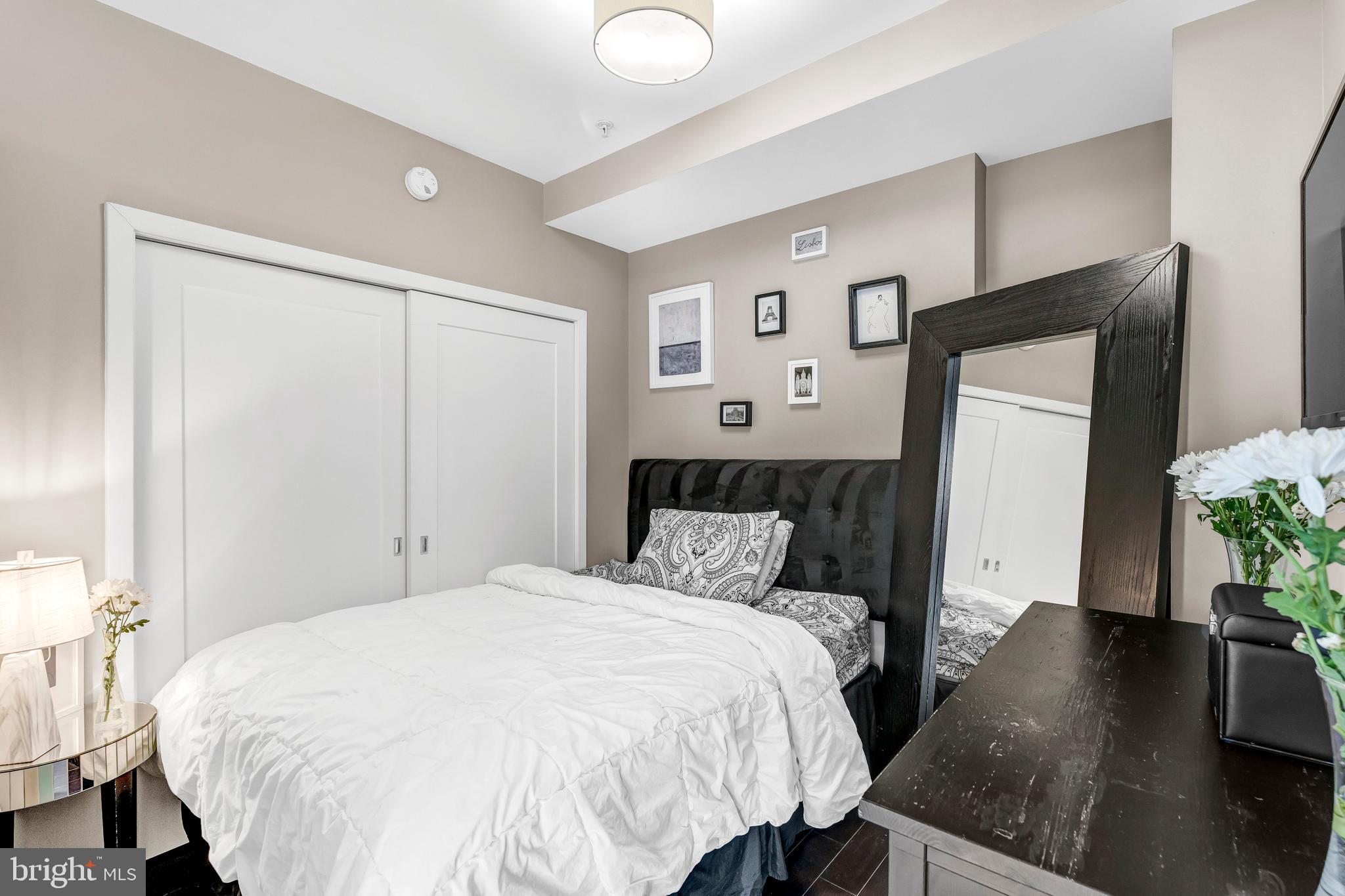 1320 Fenwick Lane, Unit 304 Silver Spring, MD 20910 - Photo 63 of 64 a bedroom with a bed and a potted plant