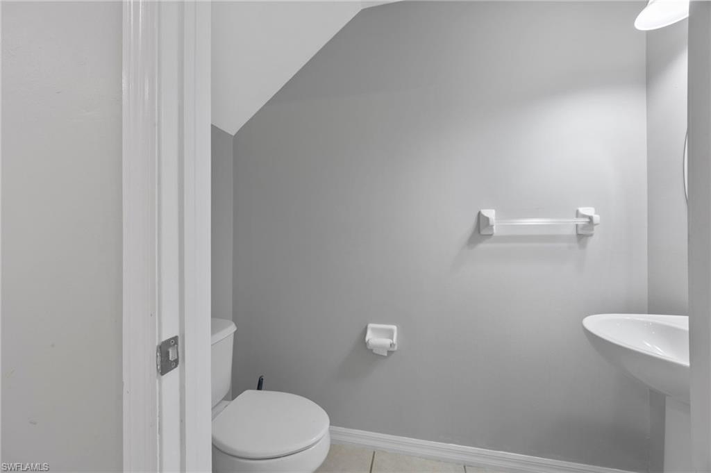 15930 Marcello Circle, Unit 242 Naples, FL 34110 - Photo 11 of 32 a bathroom with a toilet