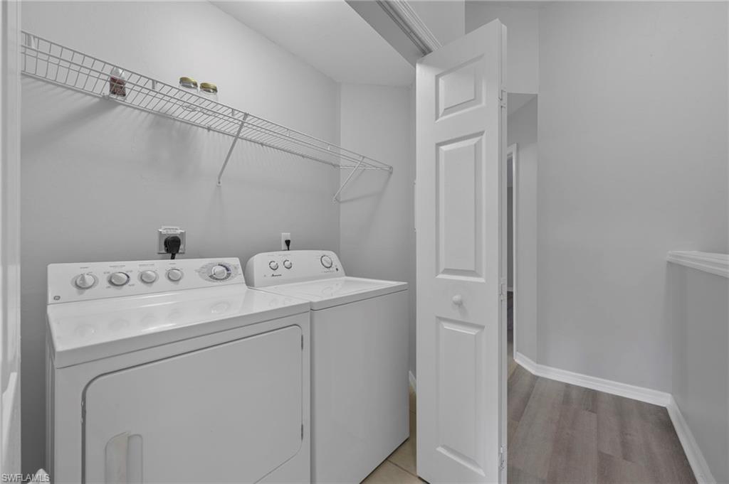 15930 Marcello Circle, Unit 242 Naples, FL 34110 - Photo 22 of 32 a utility room with dryer and washer