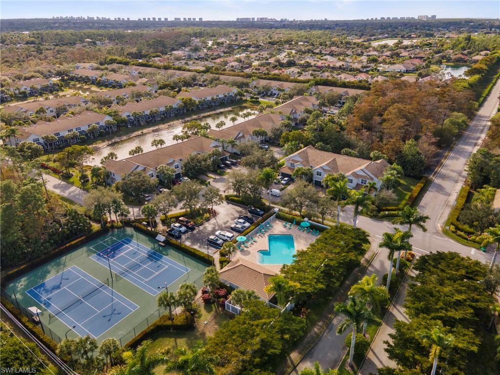 15930 Marcello Circle, Unit 242 Naples, FL 34110 - Photo 26 of 32 an aerial view of residential houses with outdoor space