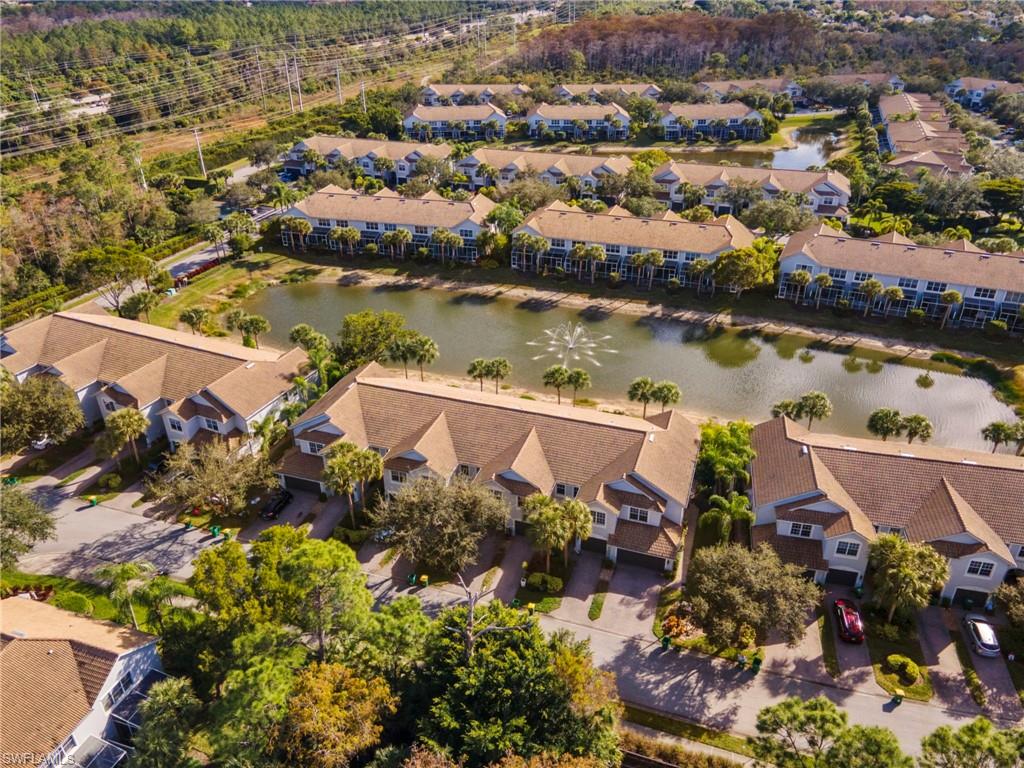 15930 Marcello Circle, Unit 242 Naples, FL 34110 - Photo 27 of 32 an aerial view of a house with a lake view
