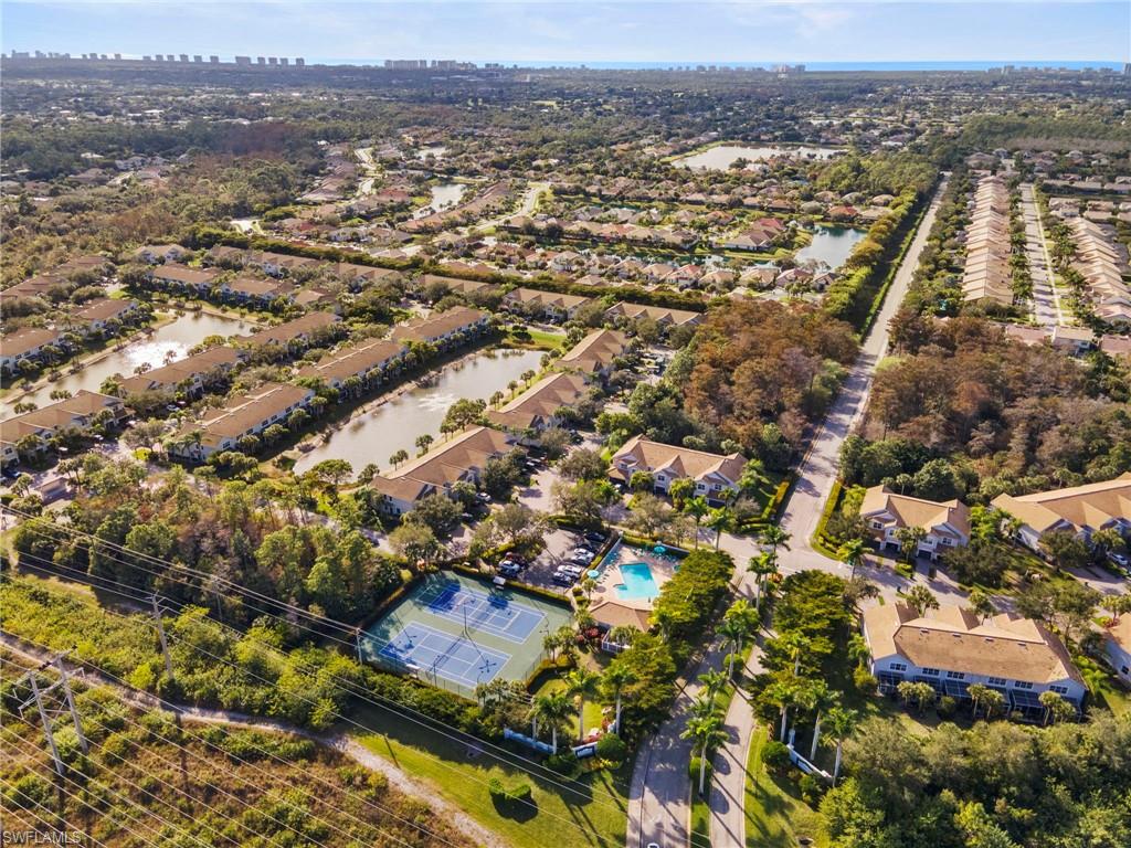 15930 Marcello Circle, Unit 242 Naples, FL 34110 - Photo 30 of 32 an aerial view of residential building and lake view