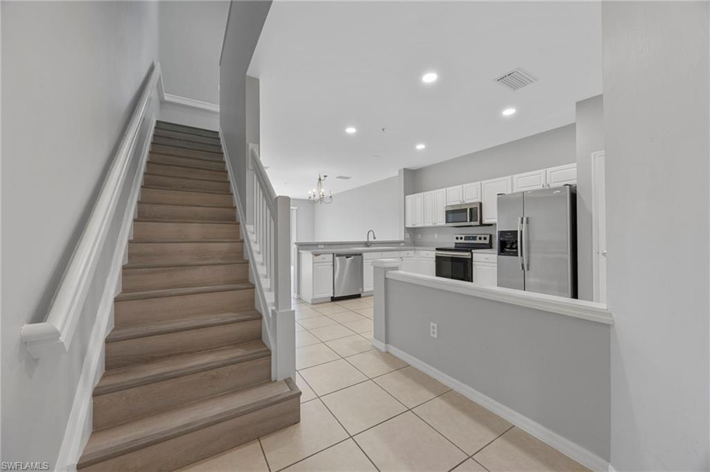 15930 Marcello Circle, Unit 242 Naples, FL 34110 - Photo 5 of 32 a view of kitchen with cabinets and refrigerator