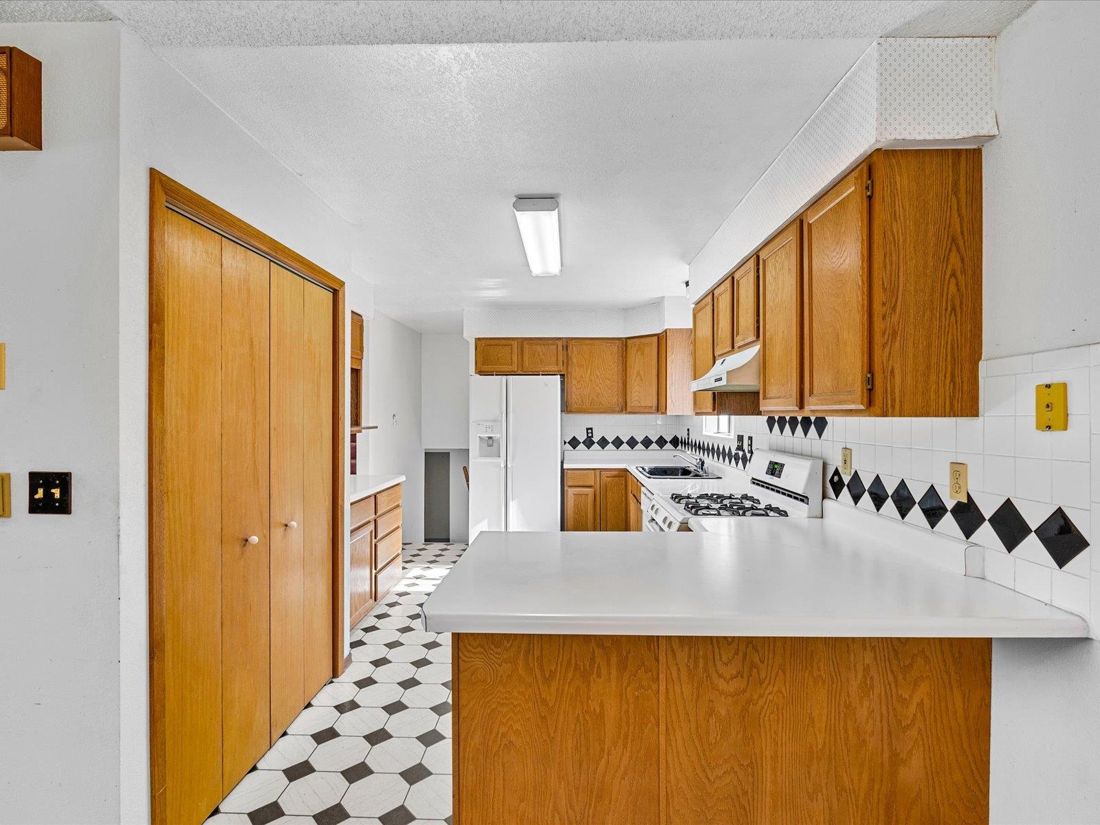 1425 19 Road Fruita, CO 81521 - Photo 15 of 42 a kitchen with a refrigerator a sink and a window