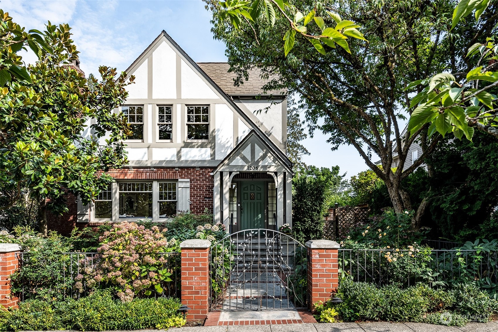 a front view of house with a garden