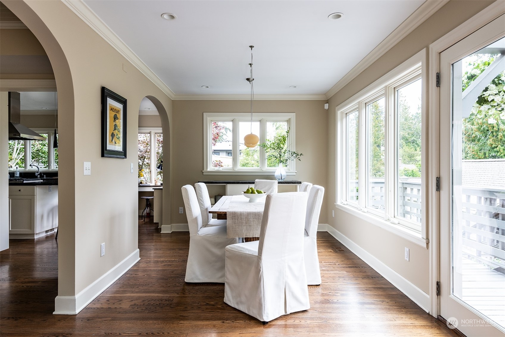 1206 37th Avenue East Seattle, WA 98112 - Photo 18 of 34 a view of a dining room with furniture windows and wooden floor