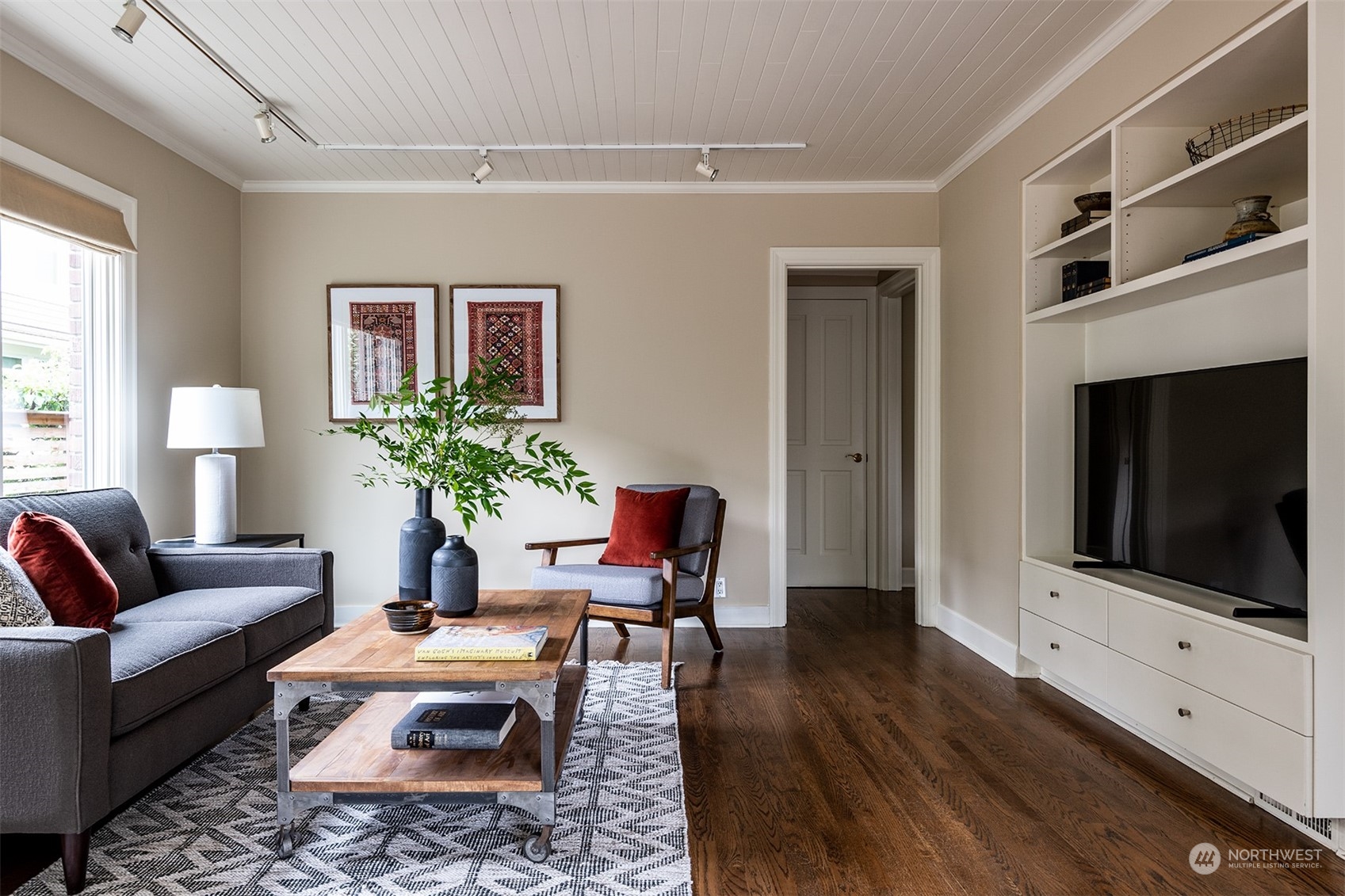 1206 37th Avenue East Seattle, WA 98112 - Photo 20 of 34 a living room with furniture a flat screen tv and a fireplace