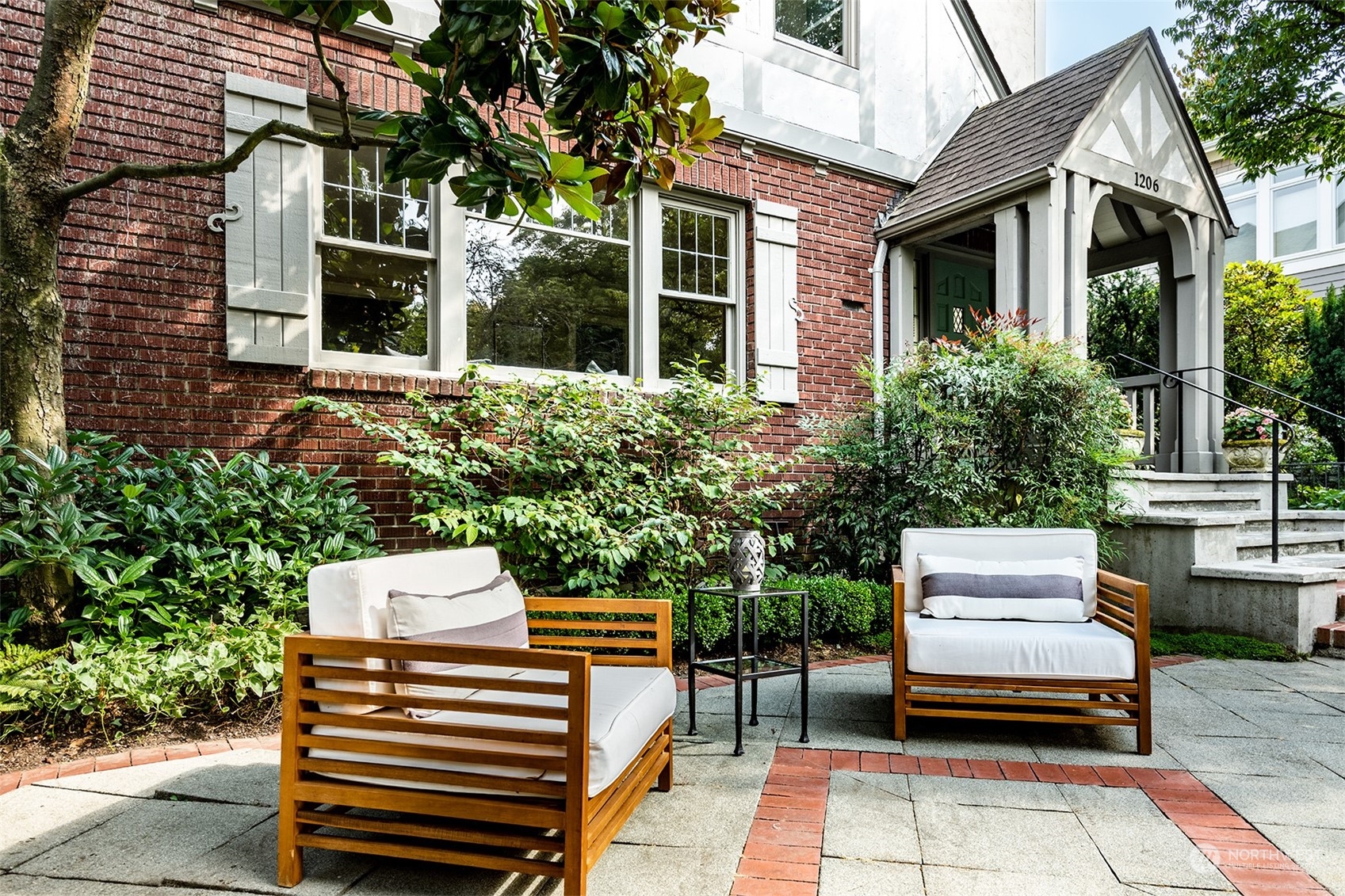 1206 37th Avenue East Seattle, WA 98112 - Photo 2 of 34 a wooden bench sitting in front of a building