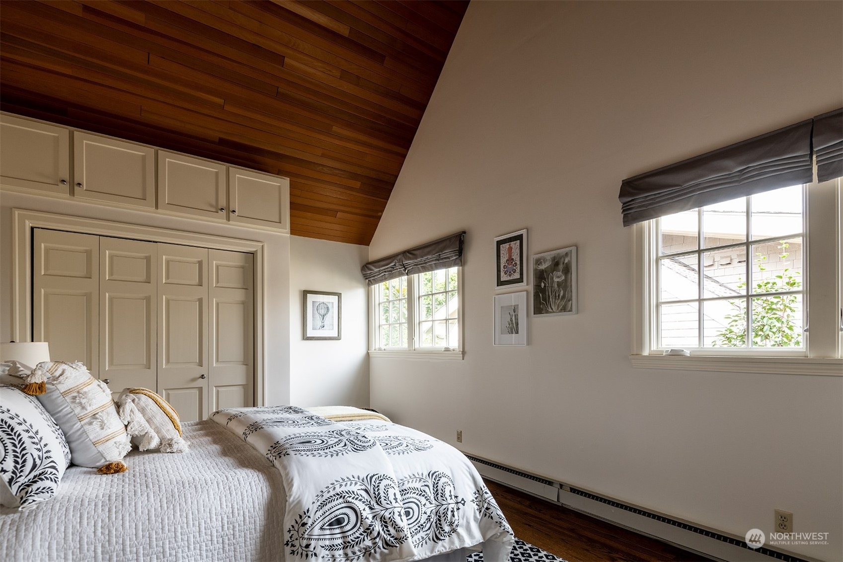 1206 37th Avenue East Seattle, WA 98112 - Photo 29 of 34 a bedroom with a bed wooden floor and window
