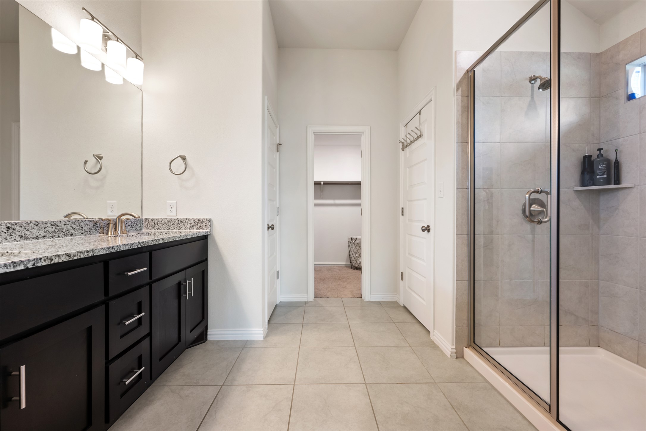 303 Cold Riv Run Kyle, TX 78640 - Photo 18 of 40 Lovely primary bathroom with dual vanity sinks.