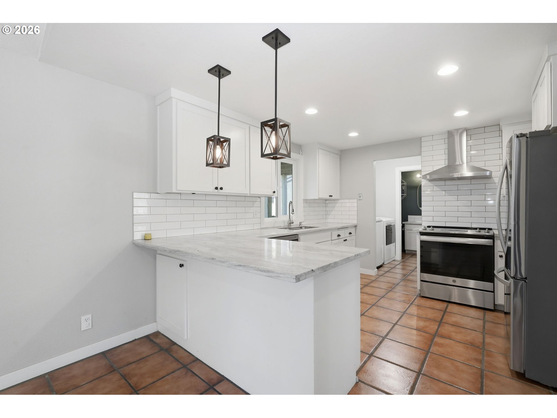 2612 Sage Street Eugene, OR 97404 - Photo 12 of 45 a kitchen with kitchen island a sink stainless steel appliances and cabinets