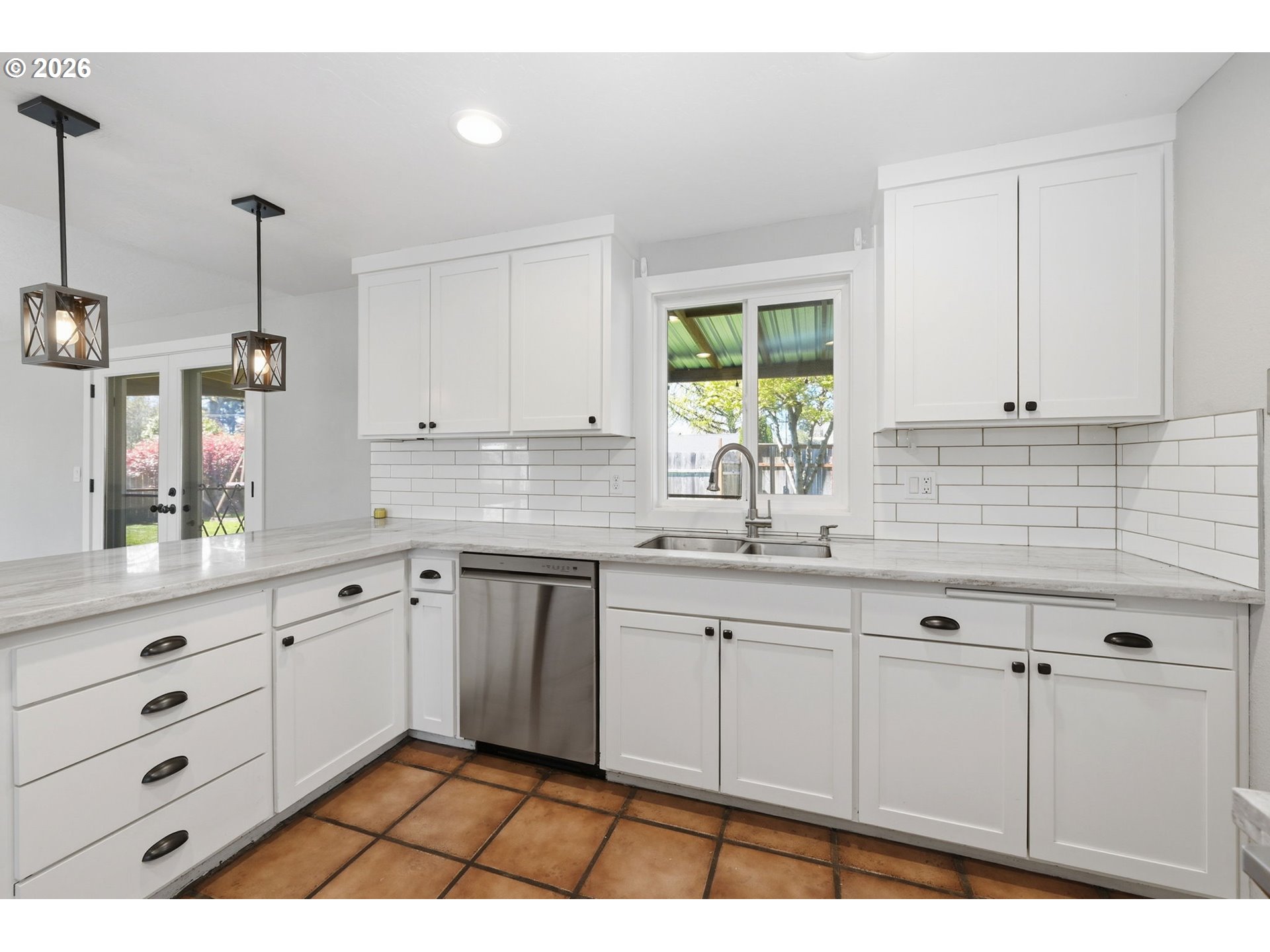 2612 Sage Street Eugene, OR 97404 - Photo 14 of 45 a kitchen with granite countertop white cabinets and window