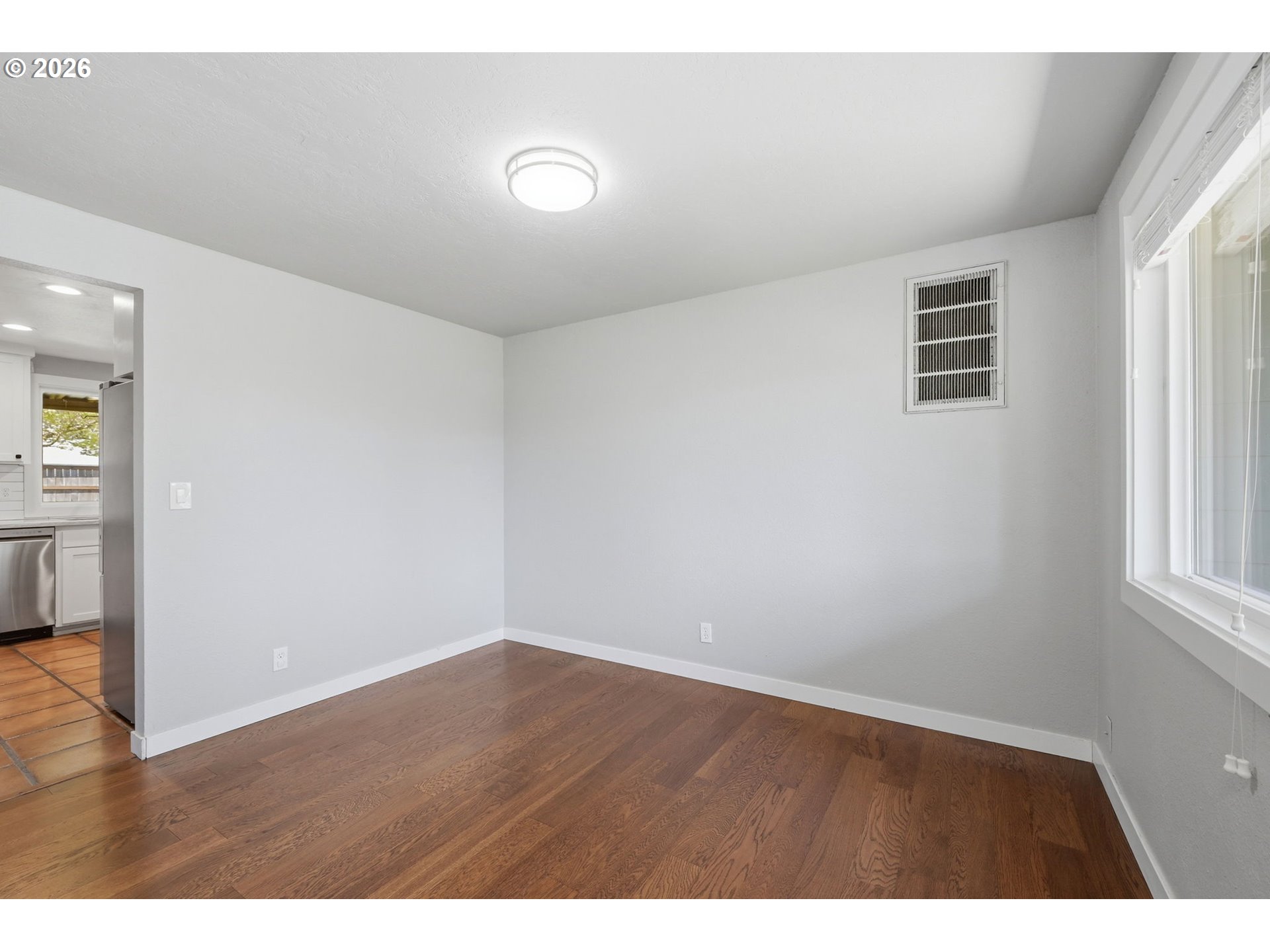 2612 Sage Street Eugene, OR 97404 - Photo 18 of 45 a view of an empty room with wooden floor and a window