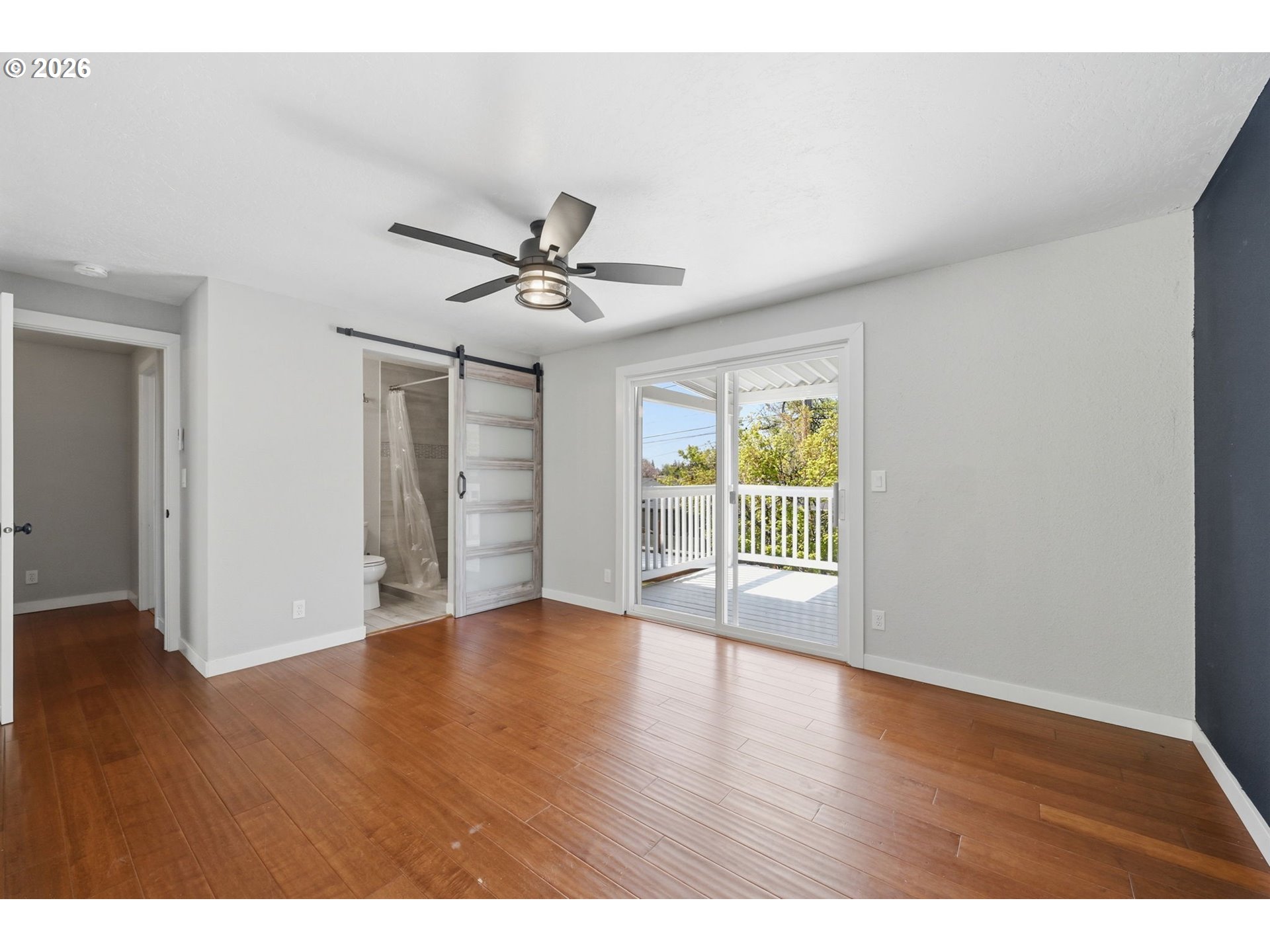 2612 Sage Street Eugene, OR 97404 - Photo 22 of 45 a view of an empty room with a window and wooden floor